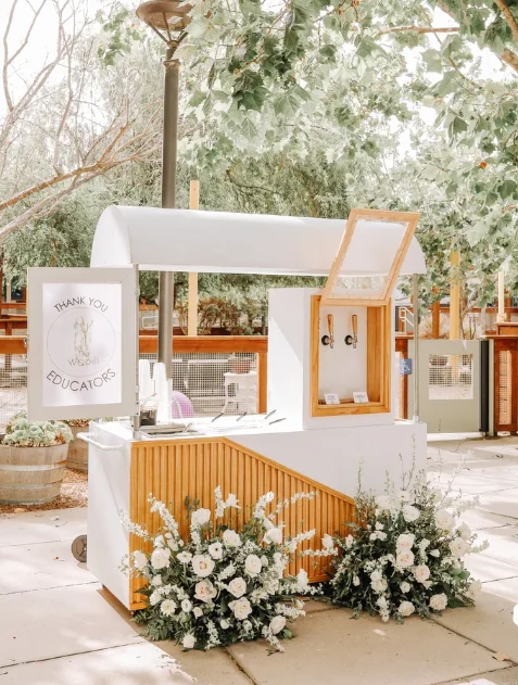 The Party Press boba on tap cart styled with white florals